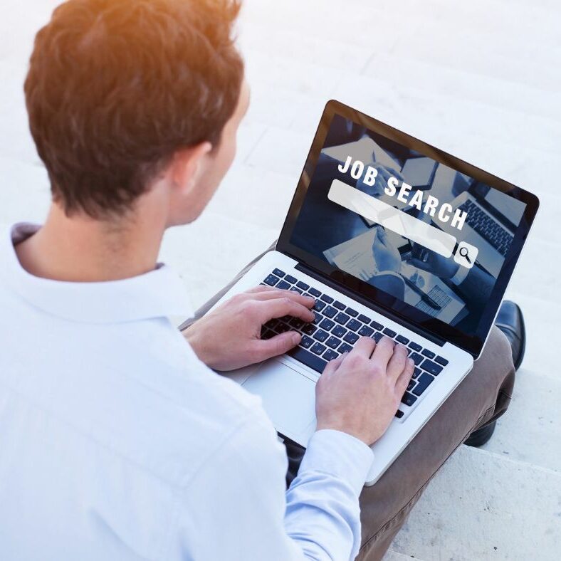 Young man on computer looking for job